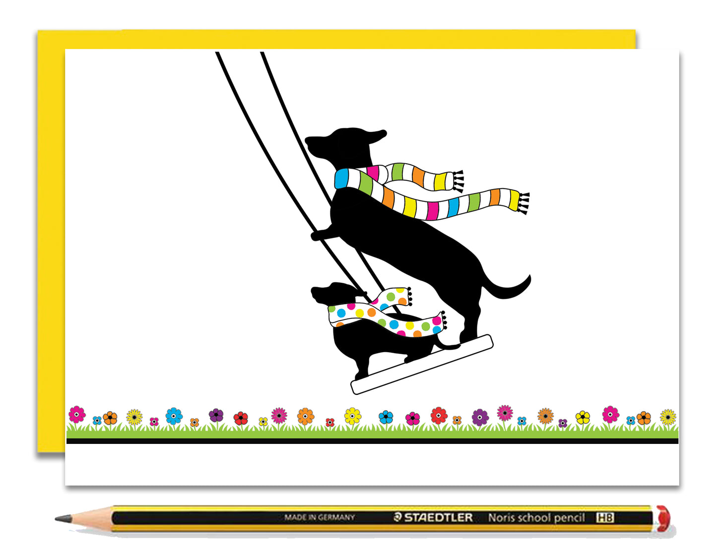 An any occasion card featuring dachshunds, Mali & Penny.  This any occasion card shows them enjoying themselves on a swing together.  Coupled with a bright, cheerful yellow envelope, with a pencil to show the scale of the card.