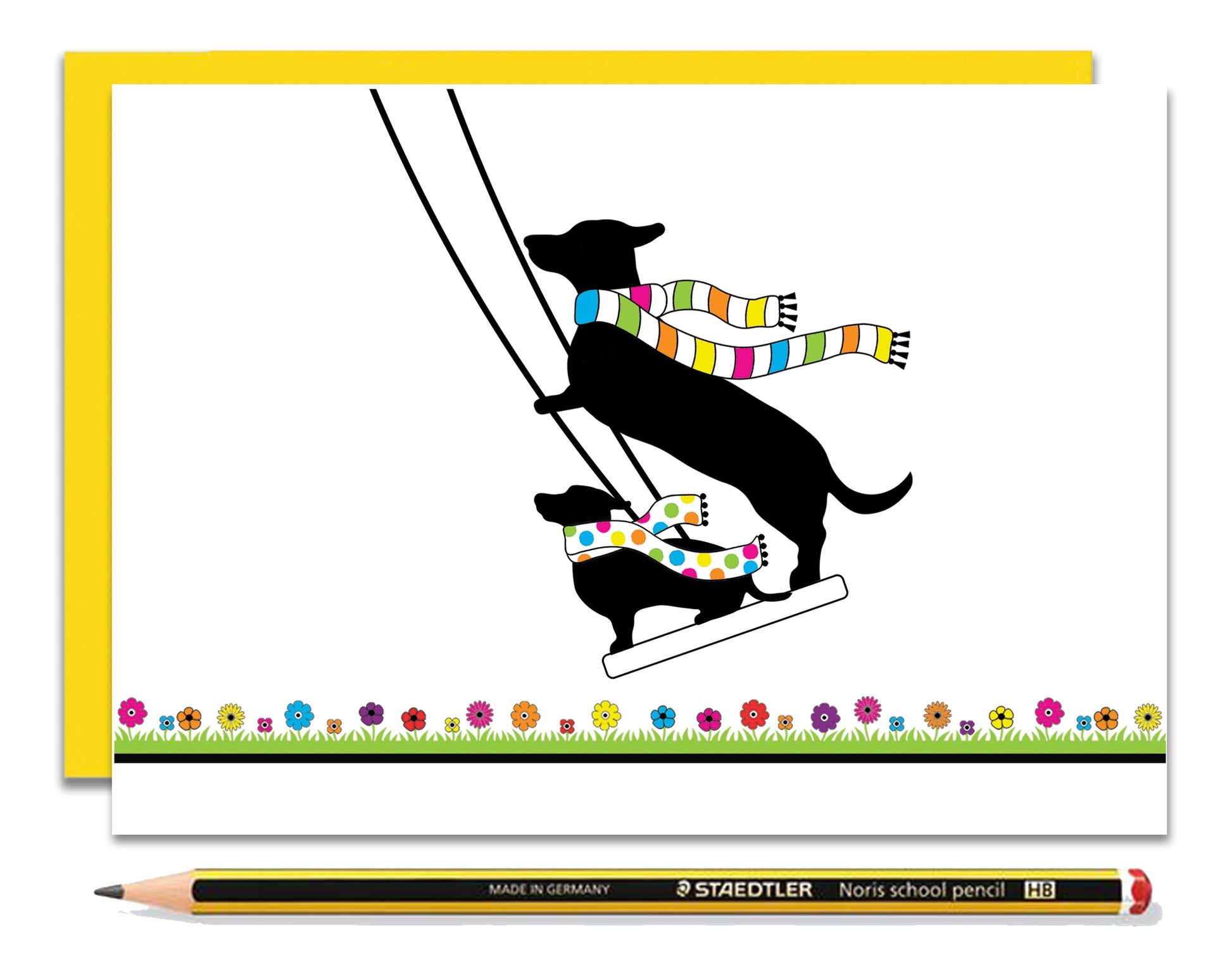 An any occasion card featuring dachshunds, Mali & Penny.  This any occasion card shows them enjoying themselves on a swing together.  Coupled with a bright, cheerful yellow envelope, with a pencil to show the scale of the card.