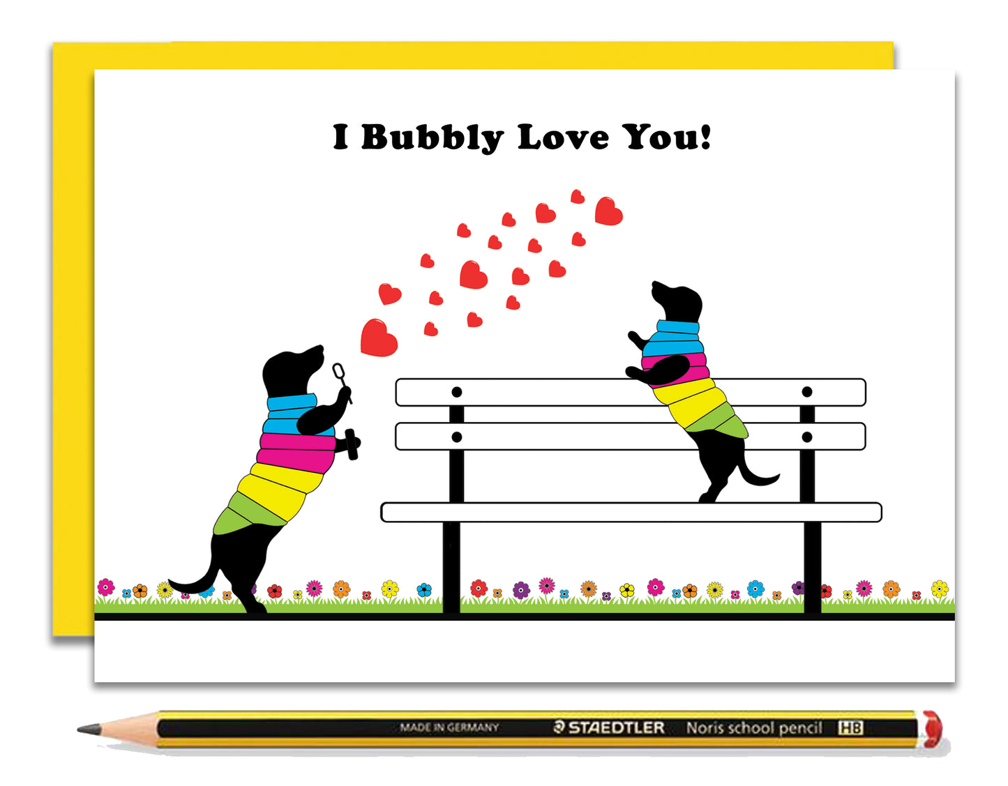 A love card featuring dachshunds, Mali & Penny.  This love card shows them on a park bench blowing and catching bubbles.  Coupled with a bright, cheerful yellow envelope, with a pencil to show the scale of the card.